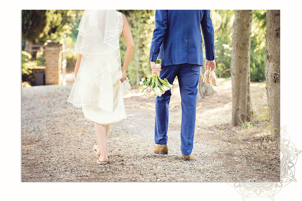 sussex wedding photography A bride and groom walking away at destination wedding in tuscany