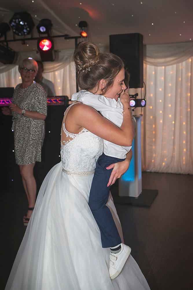 A bride hugs her son at a wedding at Parley Manor, Christchurch.