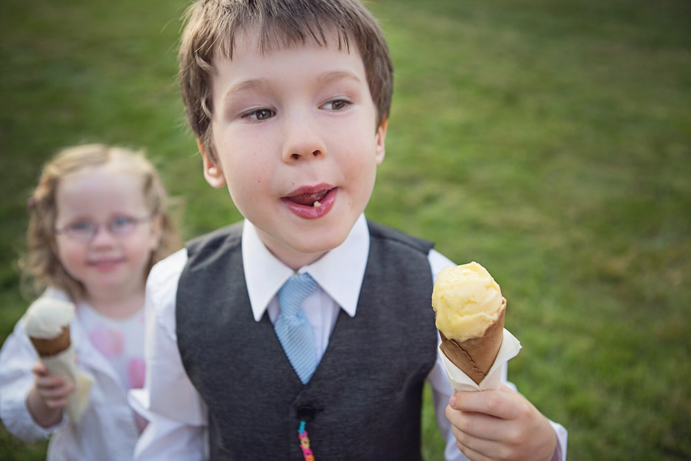 Children eating ice cream at a beautiful humanistic 1920s wedding in Henfield Sussex.