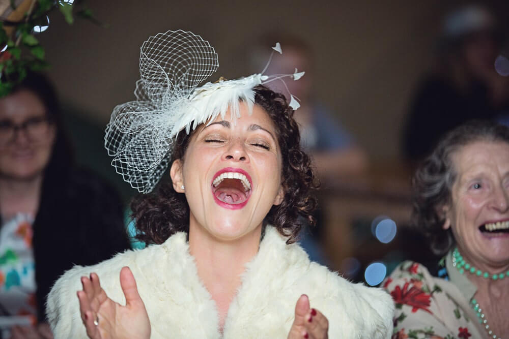 The bride laughs at a beautiful humanistic 1920s wedding in Henfield Sussex.